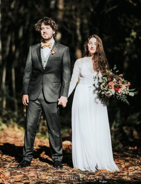 Bride and Groom outside with autumn bouquet