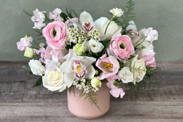 Beth's Tranquility is a sweet white and pink flower arrangement in a pink container
