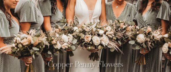 bride with bridesmaids with sophisticated autumn-hued blooms